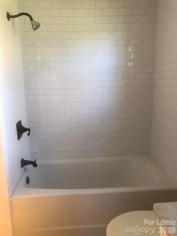a bathroom with a shower and a bathtub