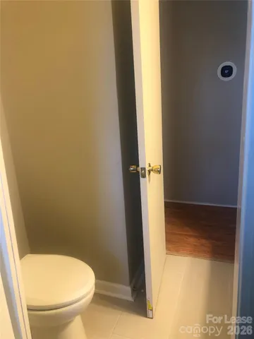 a bathroom with a granite countertop toilet and a shower