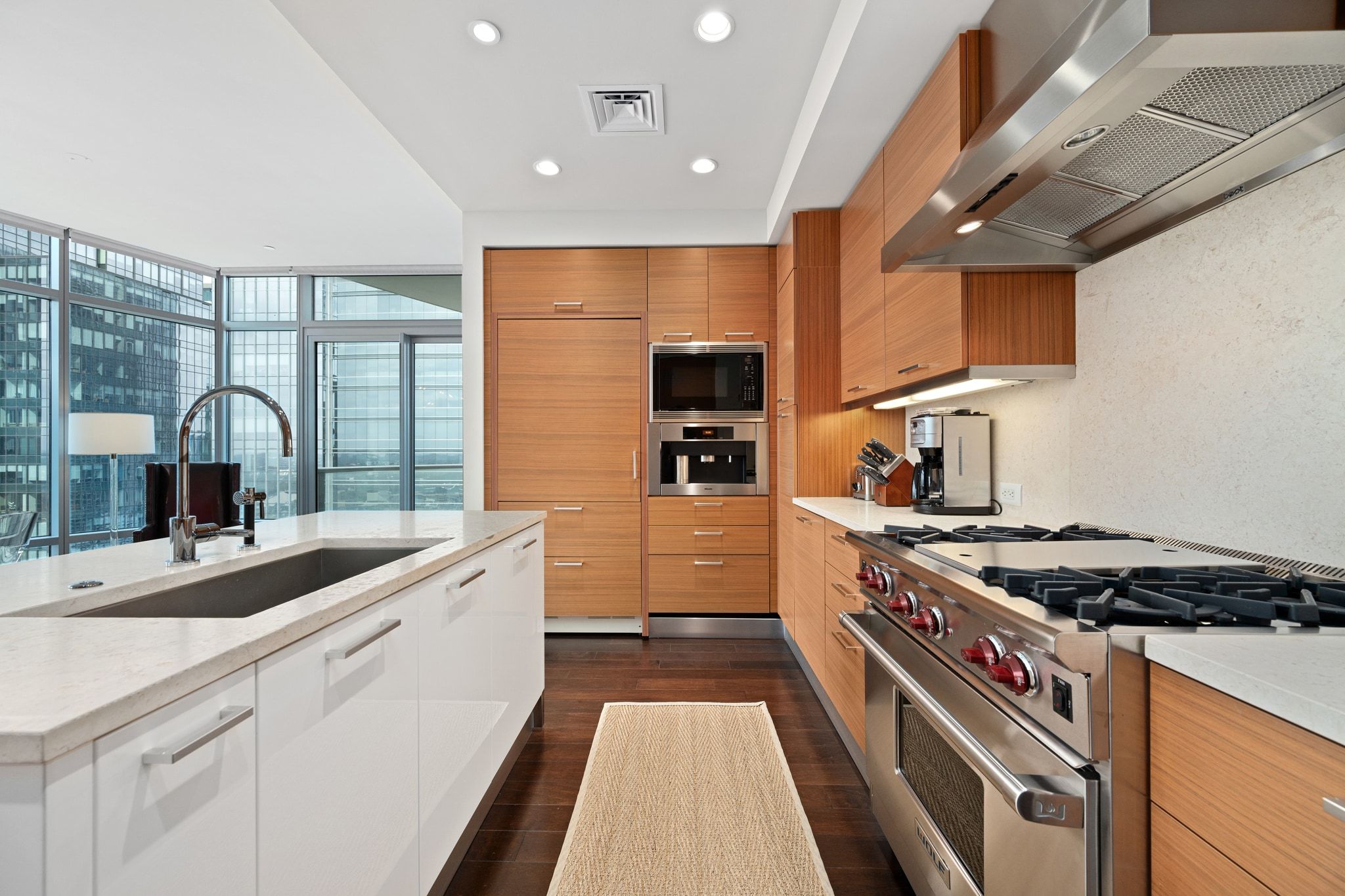 200 Congress Avenue, Unit 24E Austin, TX 78701 - Photo 14 of 40 a kitchen with stainless steel appliances granite countertop a sink and a stove