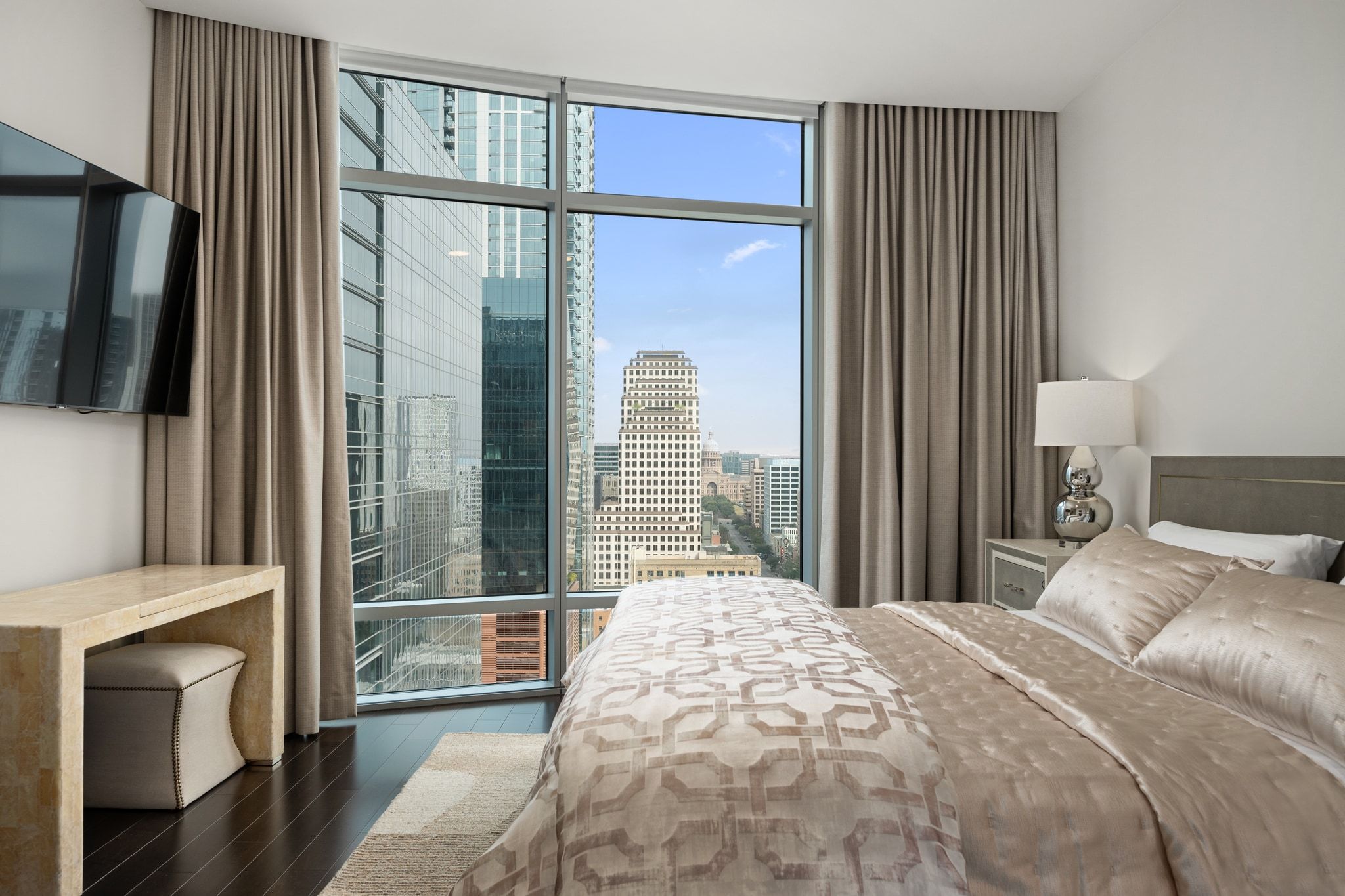 200 Congress Avenue, Unit 24E Austin, TX 78701 - Photo 17 of 40 a bedroom with a bed and a flat tv screen