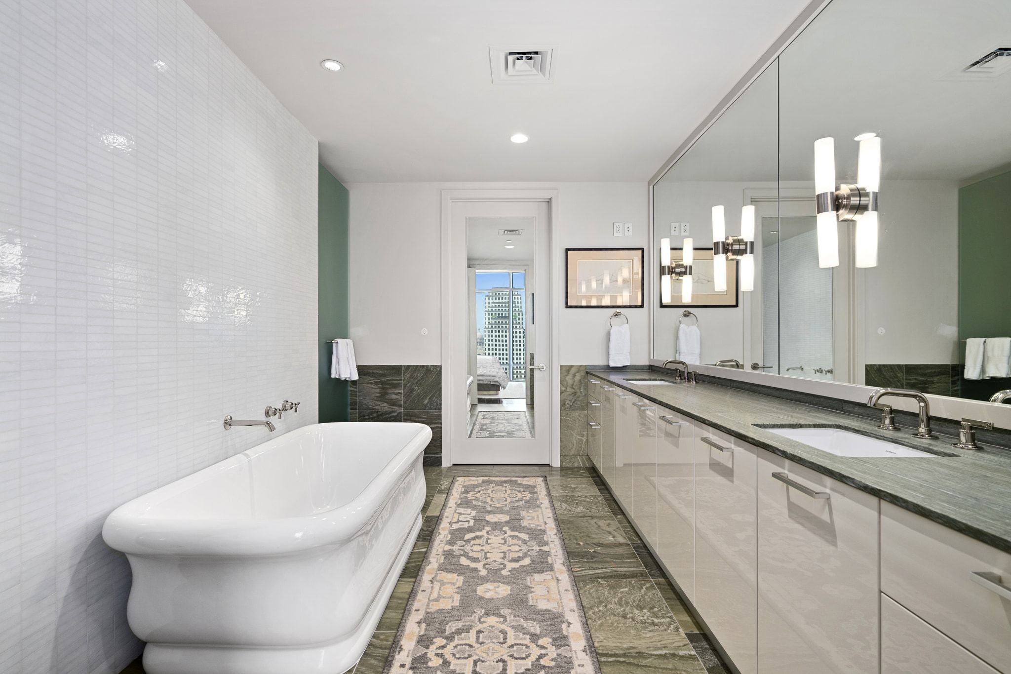 200 Congress Avenue, Unit 24E Austin, TX 78701 - Photo 18 of 40 a bathroom with a double vanity sink and mirror