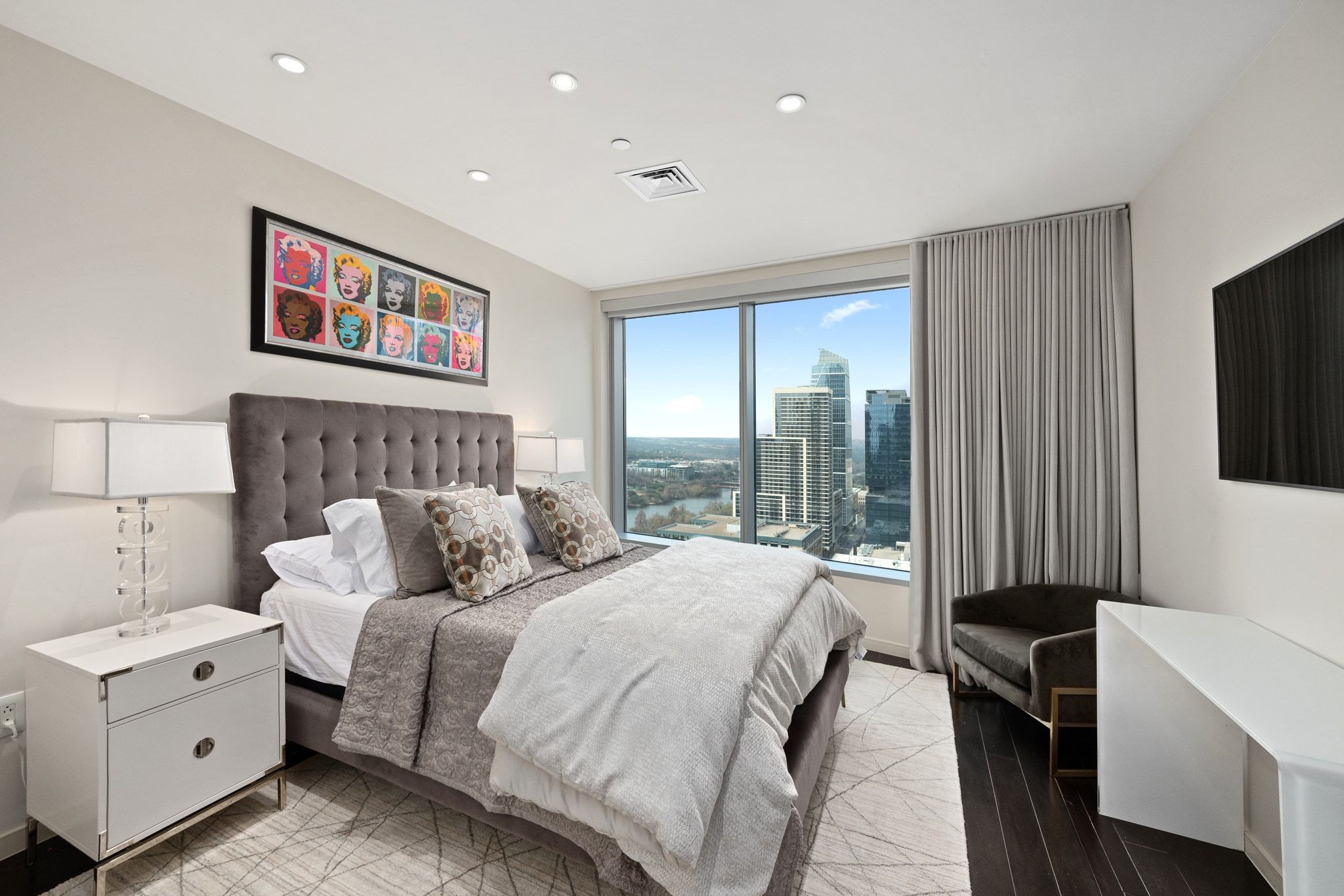 200 Congress Avenue, Unit 24E Austin, TX 78701 - Photo 22 of 40 a bedroom with a bed and a large window