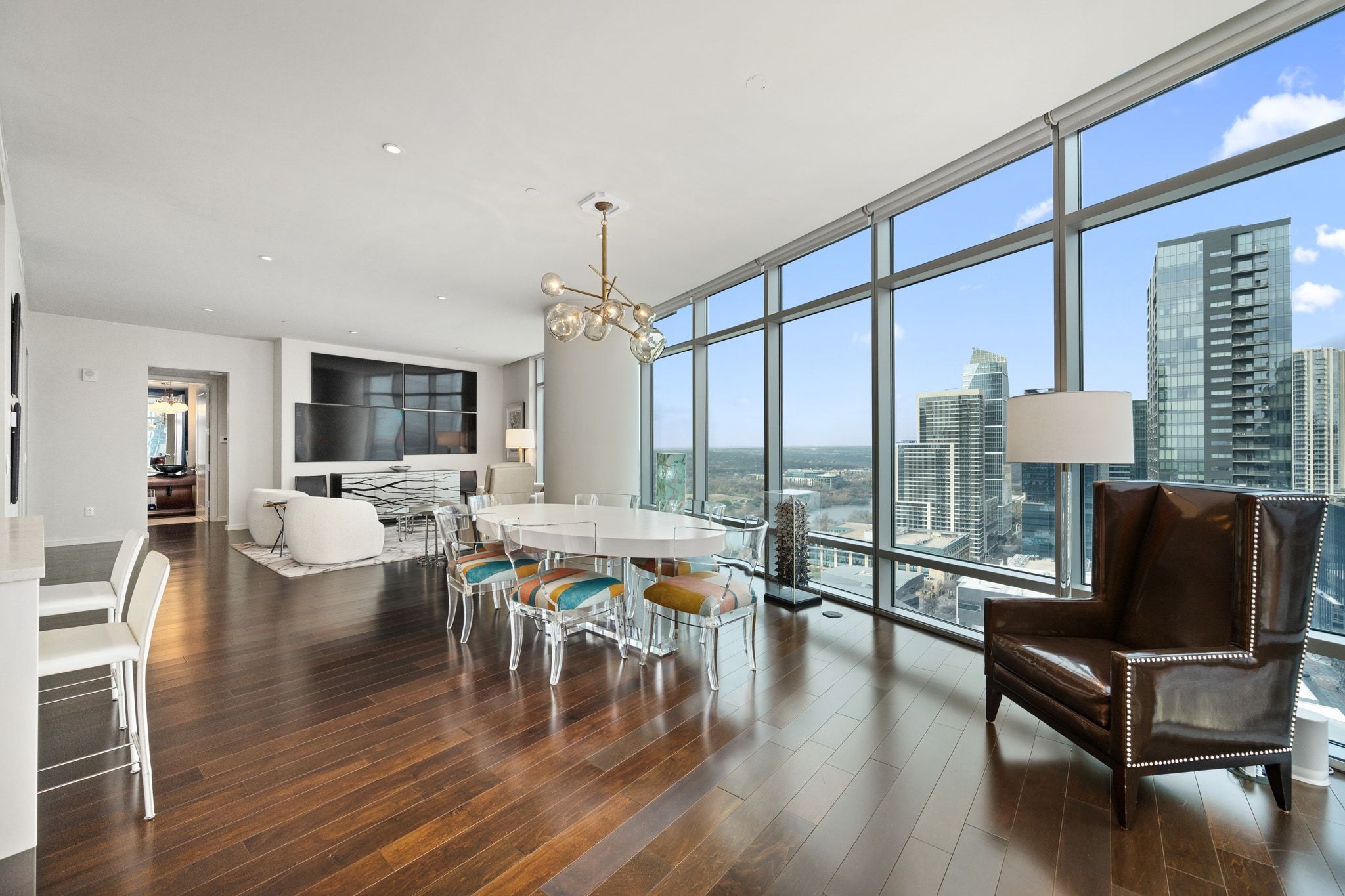 200 Congress Avenue, Unit 24E Austin, TX 78701 - Photo 9 of 40 a living room with furniture large windows and wooden floor