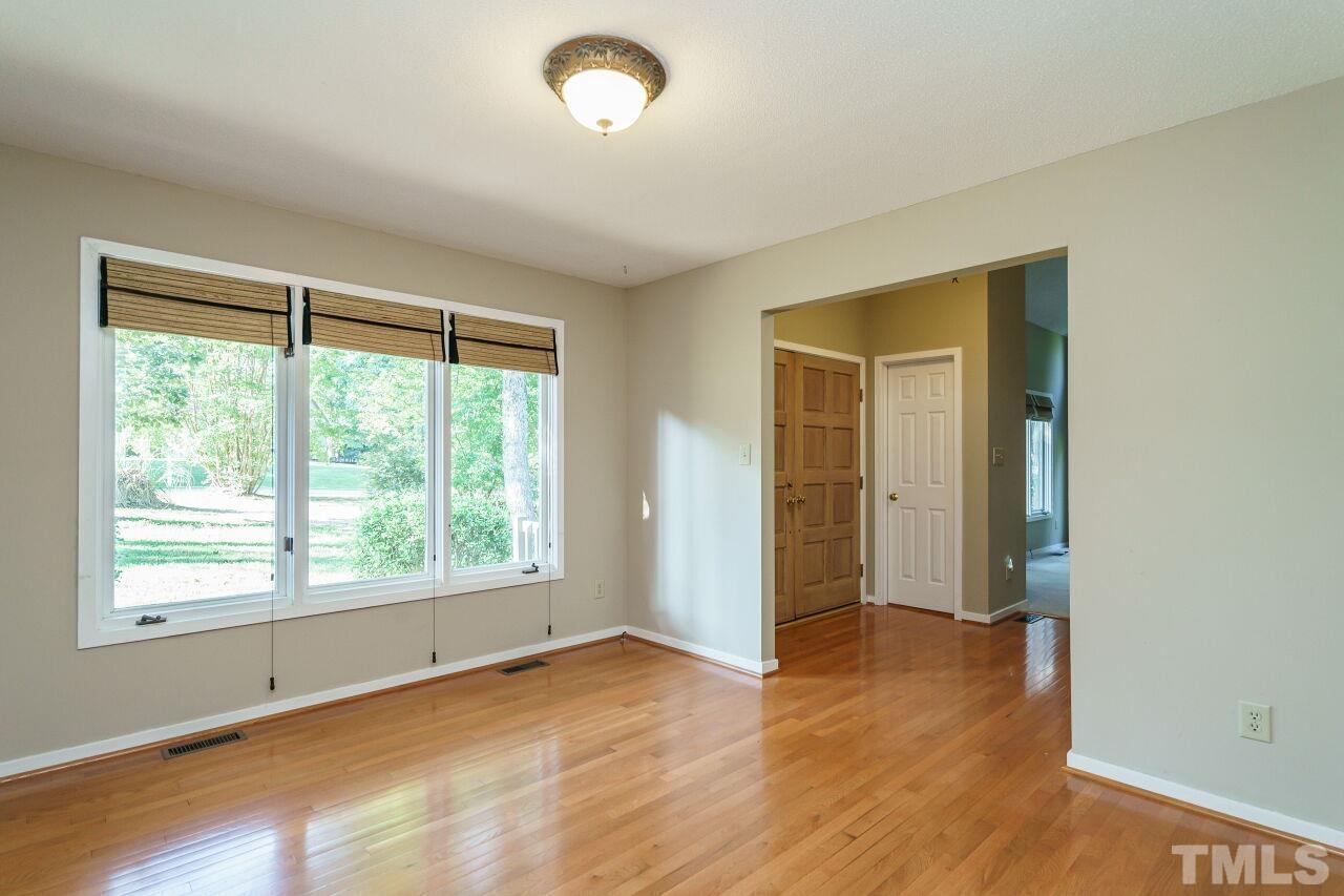 12213 Galway Drive Raleigh, NC 27613 - Photo 11 of 31 an empty room with wooden floor and windows
