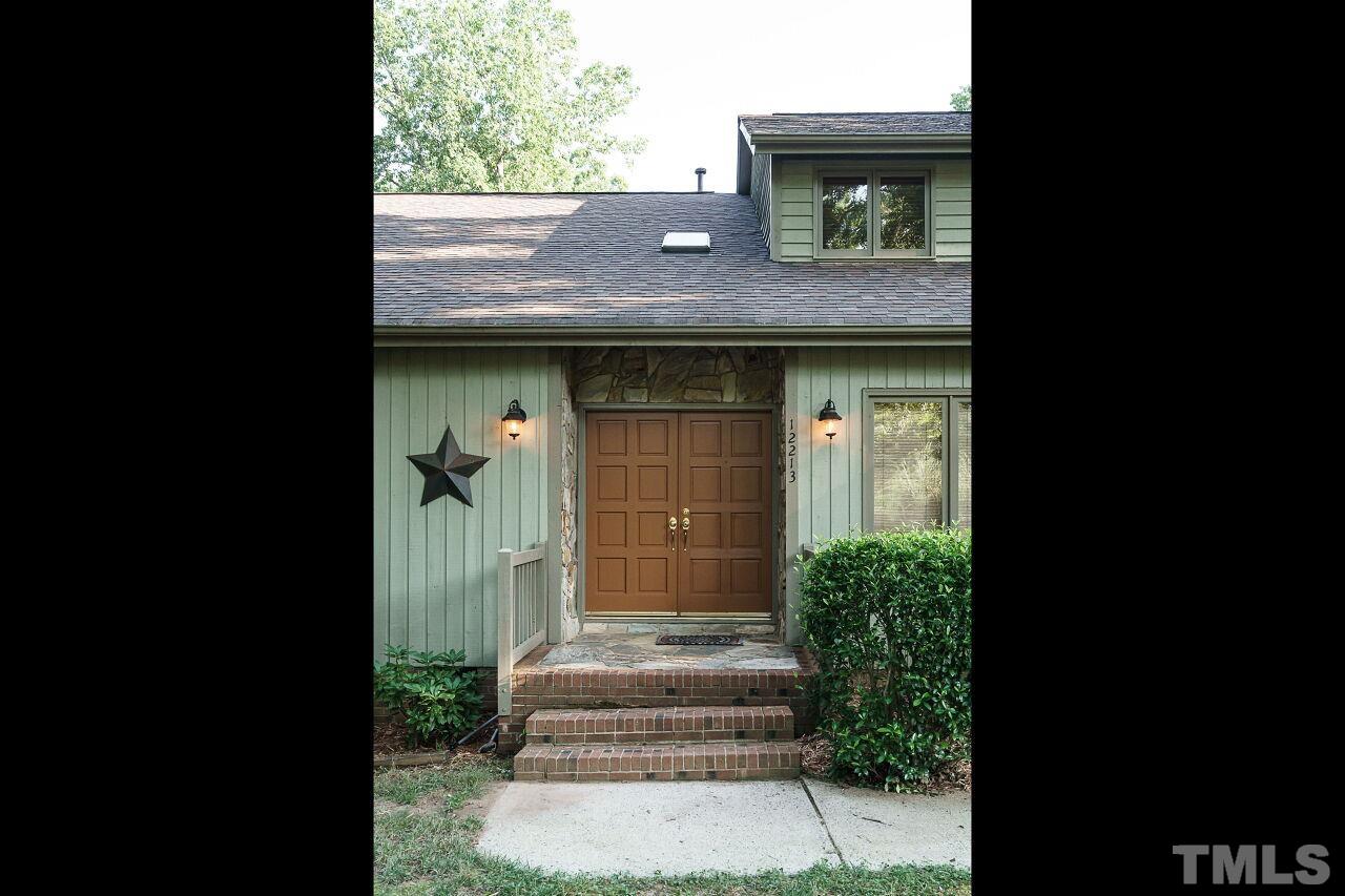 12213 Galway Drive Raleigh, NC 27613 - Photo 2 of 31 a front view of a house with a garden