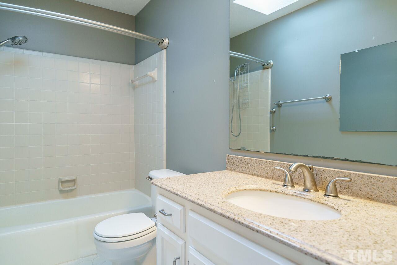12213 Galway Drive Raleigh, NC 27613 - Photo 25 of 31 a bathroom with a granite countertop sink toilet and shower