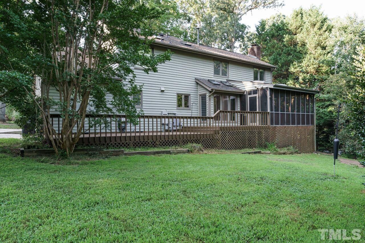 12213 Galway Drive Raleigh, NC 27613 - Photo 30 of 31 a view of a house with a yard and a wooden deck