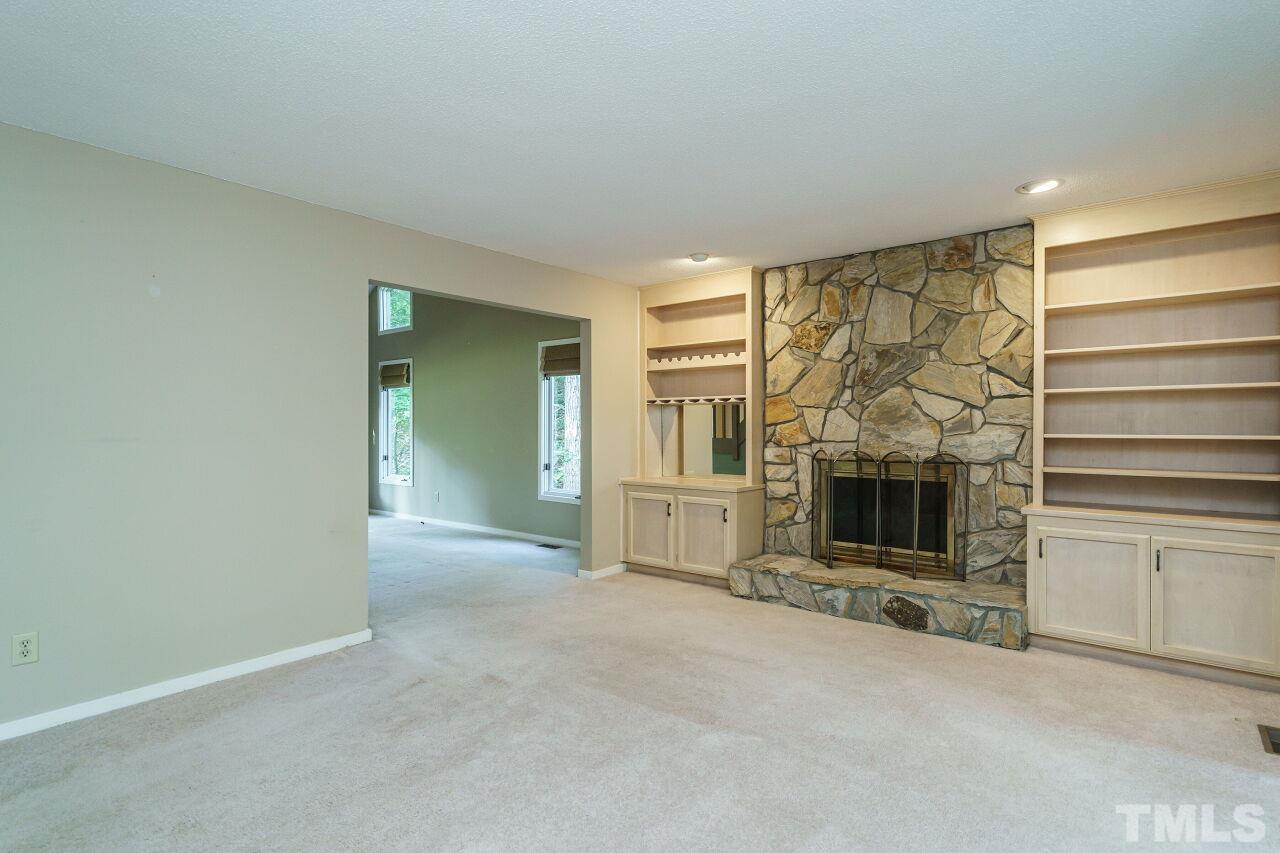 12213 Galway Drive Raleigh, NC 27613 - Photo 7 of 31 a view of a livingroom with an empty space and a fireplace