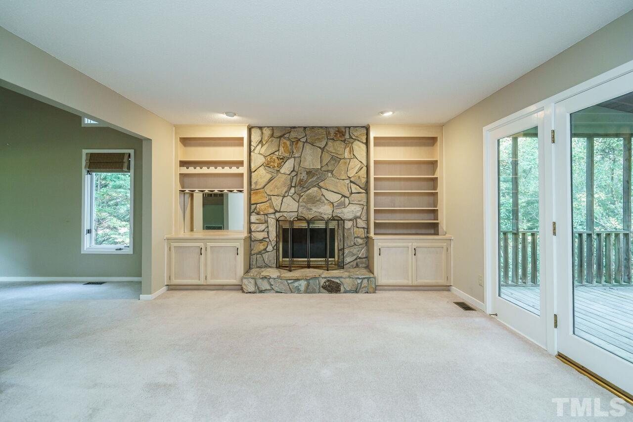 12213 Galway Drive Raleigh, NC 27613 - Photo 8 of 31 a view of an empty room with a fireplace and a window