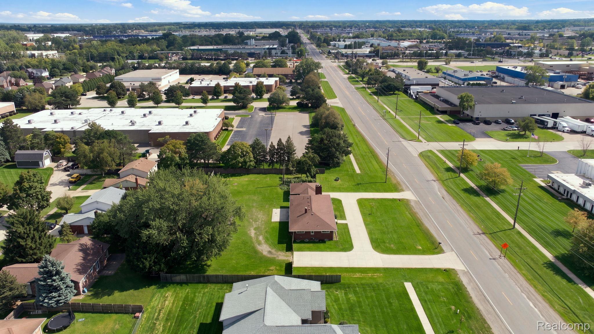 5353 18 Mile Road Sterling Heights, MI 48314 - Photo 48 of 53 Expansive aerial perspective showcasing varied commercial structures and residential rooftops