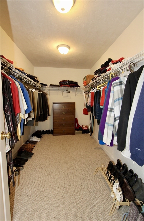 159 Mower Street Worcester, MA 01602 - Photo 17 of 27 a view of walk in closet with clothes and shoes