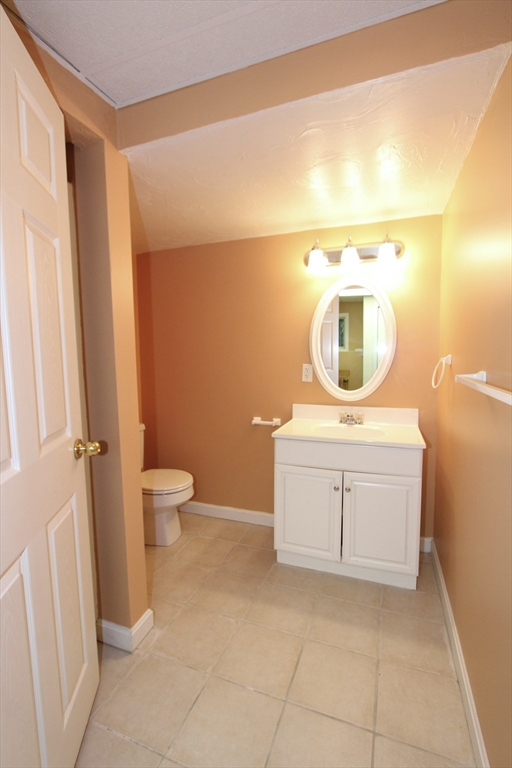 159 Mower Street Worcester, MA 01602 - Photo 22 of 27 a bathroom with a toilet sink and mirror