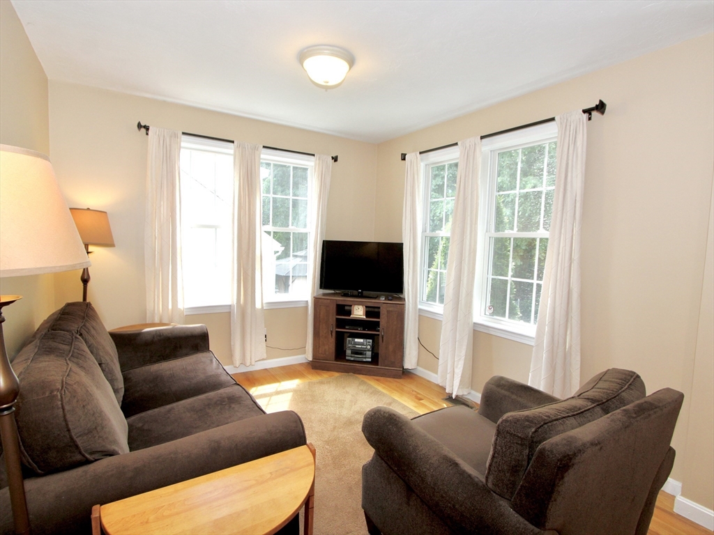 159 Mower Street Worcester, MA 01602 - Photo 5 of 27 a living room with furniture window and a flat screen tv