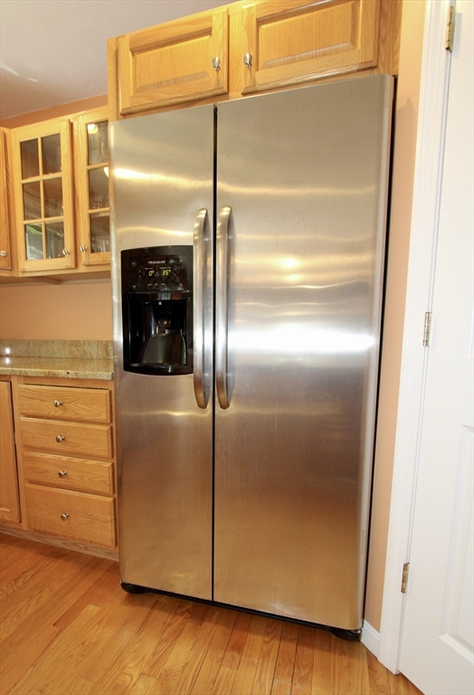 159 Mower Street Worcester, MA 01602 - Photo 7 of 27 a kitchen with a refrigerator and a wooden floor