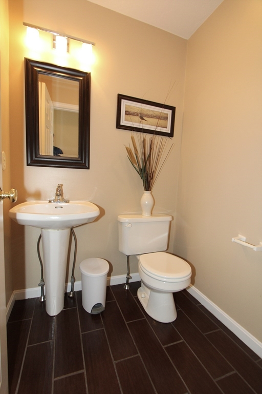 159 Mower Street Worcester, MA 01602 - Photo 8 of 27 a bathroom with a toilet sink and mirror
