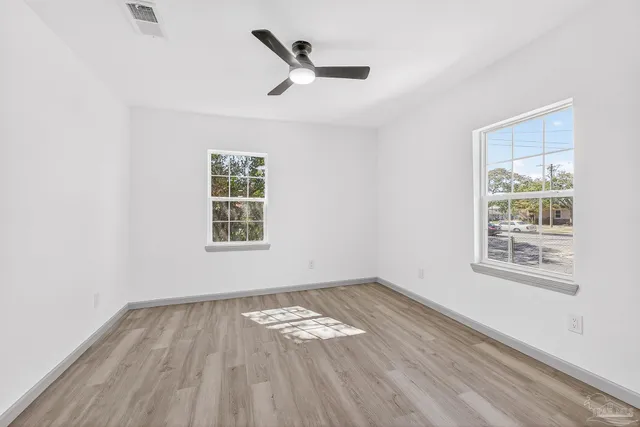 wooden floor in an empty room with a window
