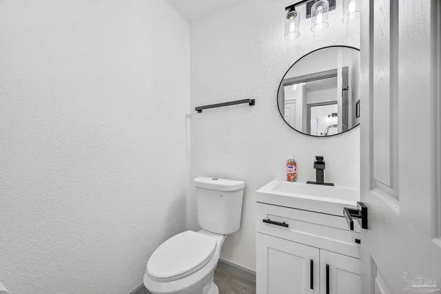 a white toilet sitting next to a bathroom sink
