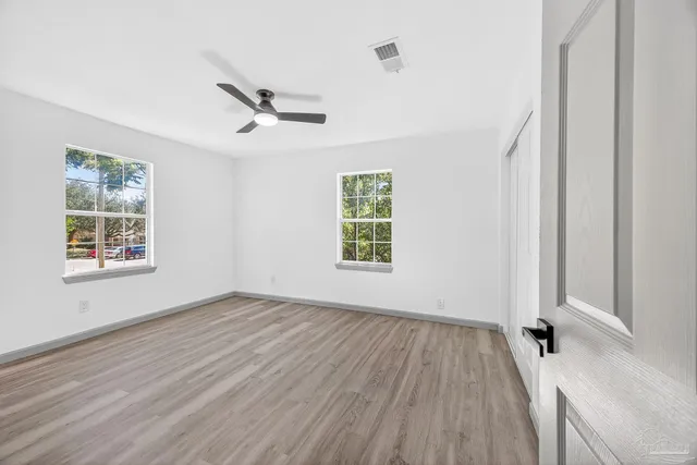 wooden floor in an empty room with a window