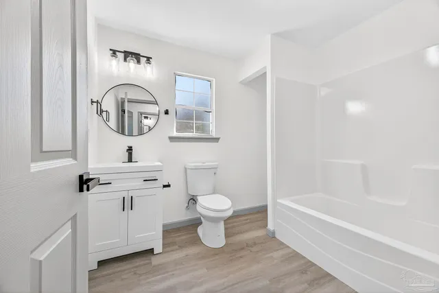 a bathroom with a toilet a sink and a bathtub