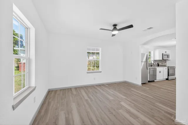 wooden floor in an empty room with a window