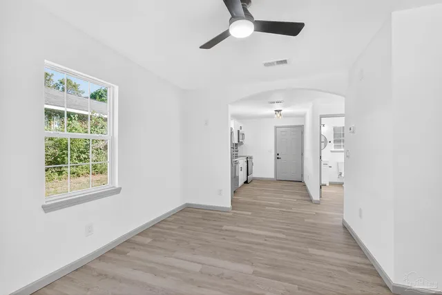 wooden floor in an empty room with a window