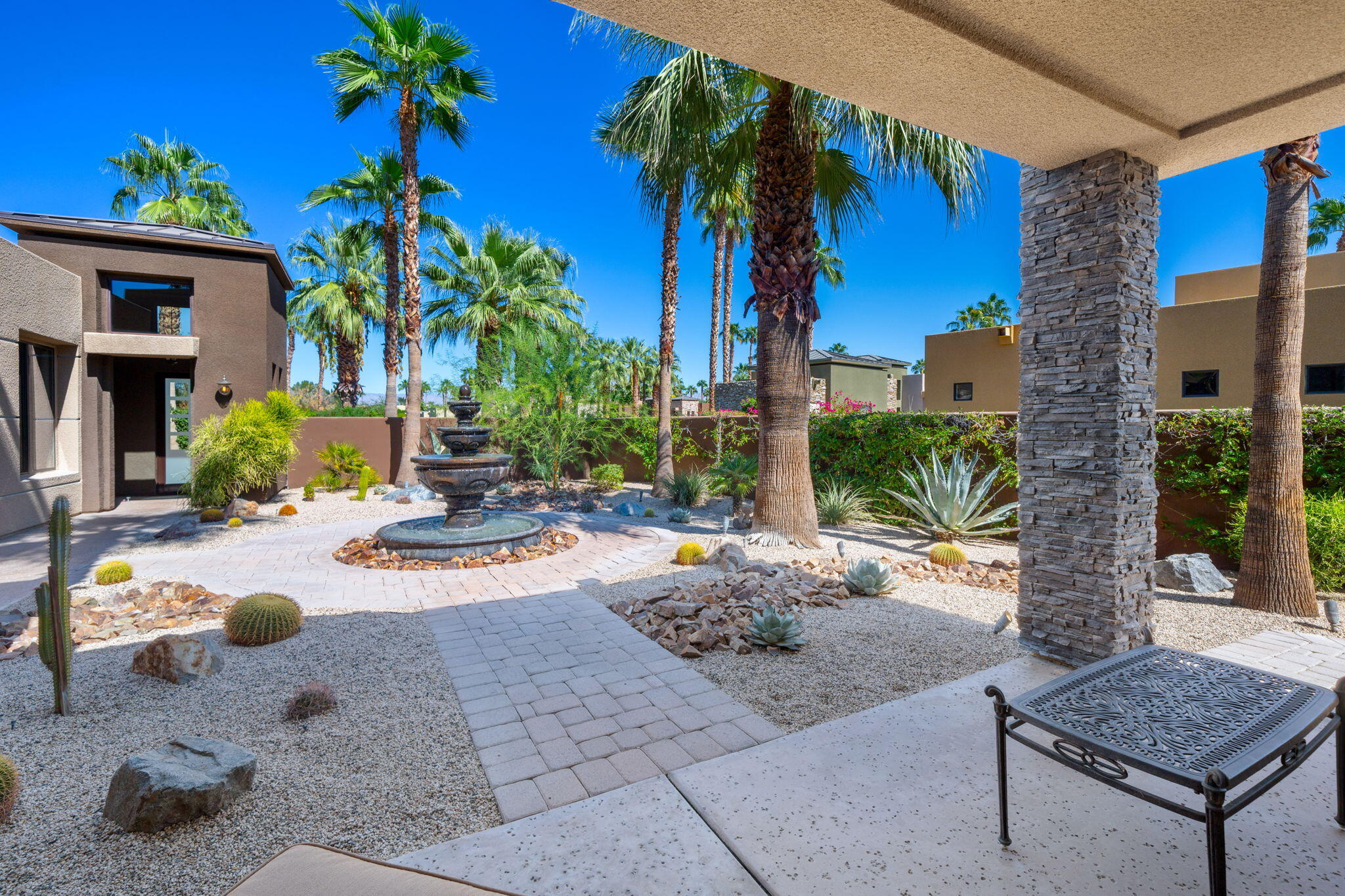 14 Dominion Court Rancho Mirage, CA 92270 - Photo 12 of 65 a view of backyard of a house with potted plants and outdoor seating