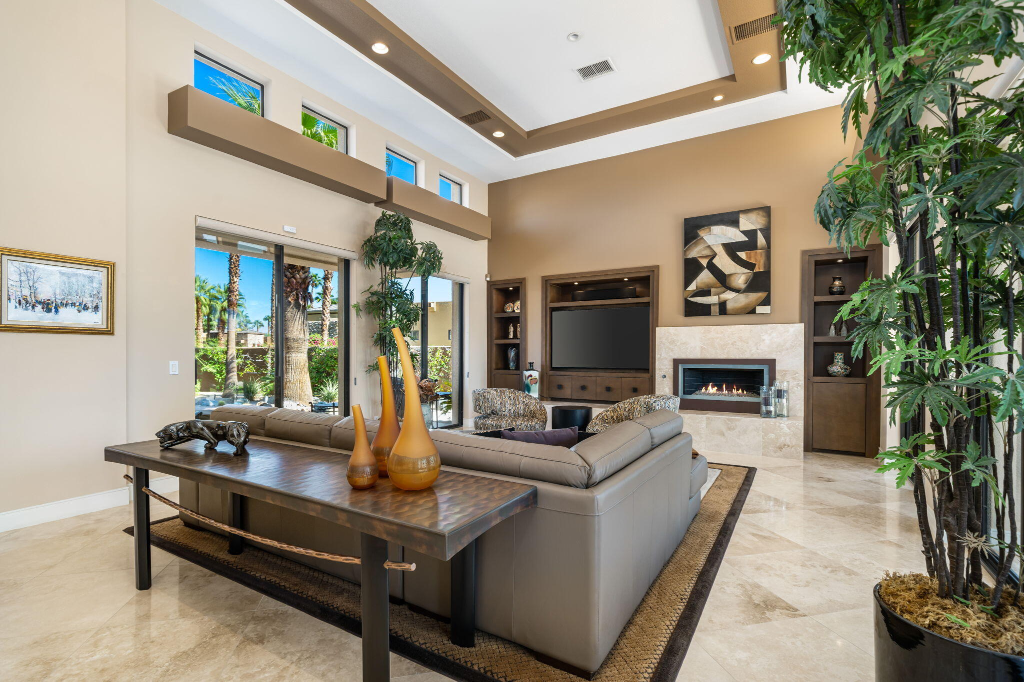 14 Dominion Court Rancho Mirage, CA 92270 - Photo 21 of 65 a living room with furniture a fireplace and a potted plant