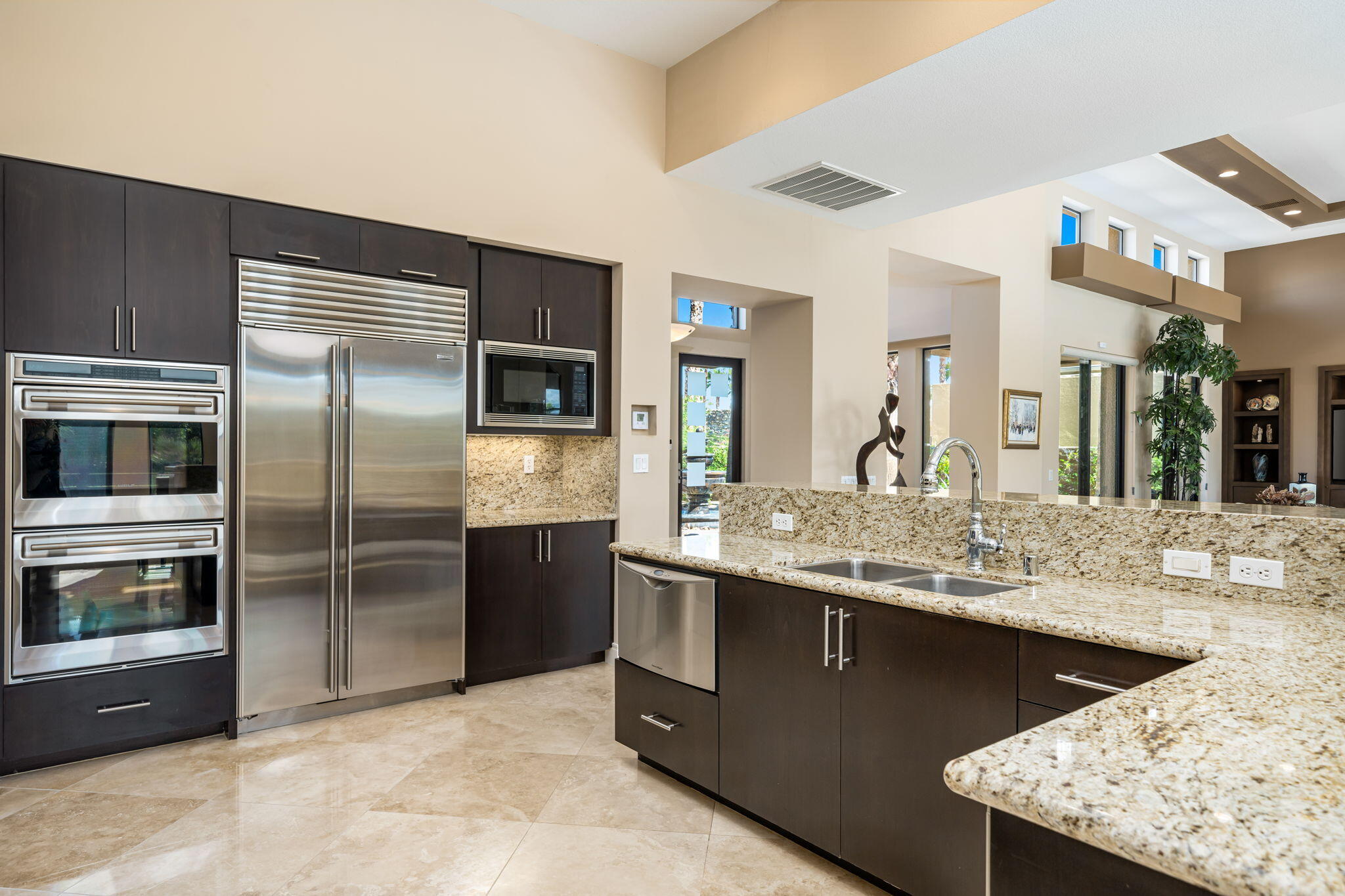 14 Dominion Court Rancho Mirage, CA 92270 - Photo 23 of 65 a kitchen with stainless steel appliances granite countertop a sink and a refrigerator