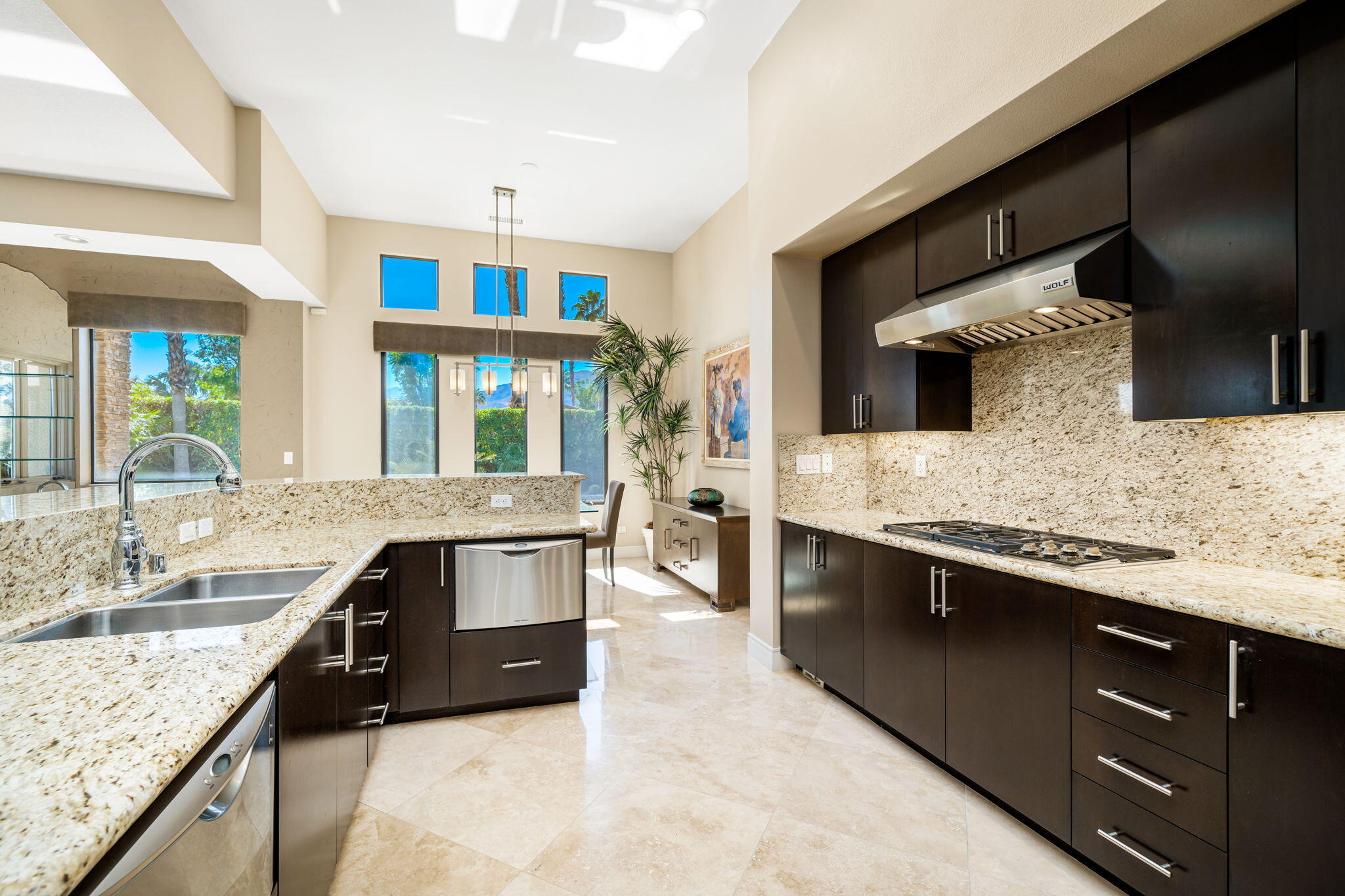 14 Dominion Court Rancho Mirage, CA 92270 - Photo 25 of 65 a kitchen with stainless steel appliances granite countertop sink stove and cabinets