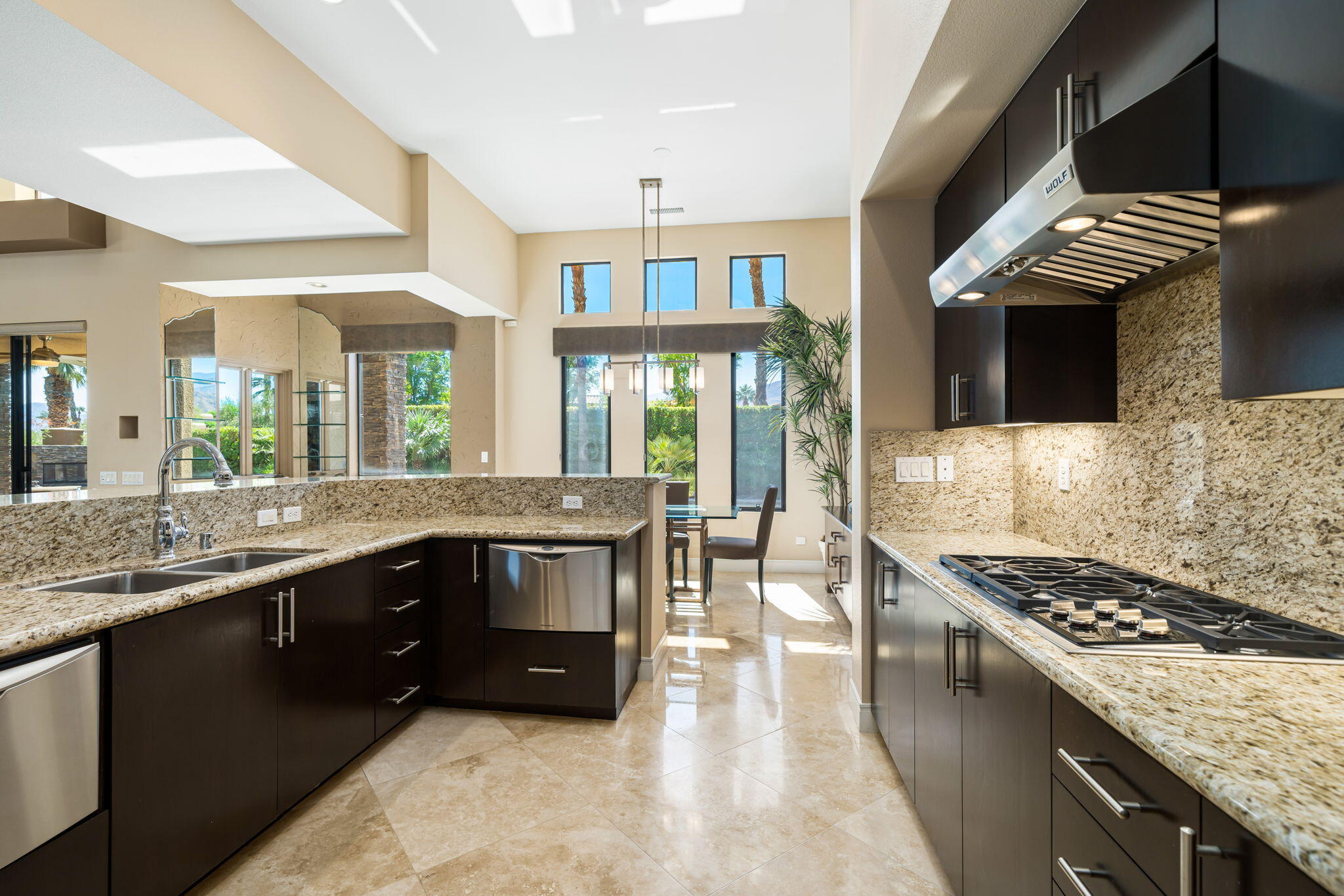 14 Dominion Court Rancho Mirage, CA 92270 - Photo 26 of 65 a kitchen with stainless steel appliances granite countertop a stove a sink and a microwave