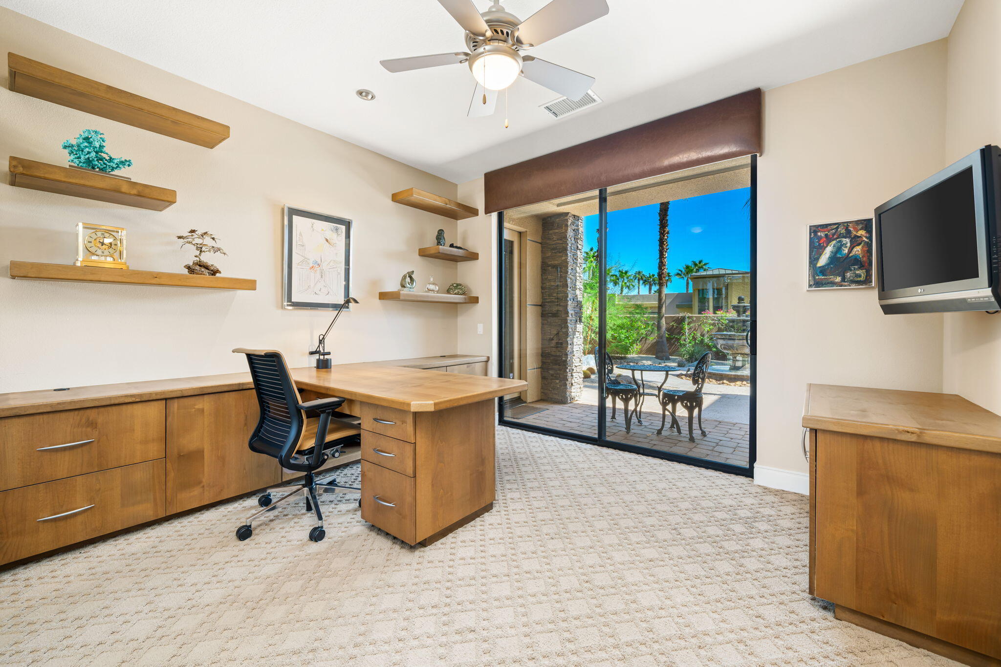 14 Dominion Court Rancho Mirage, CA 92270 - Photo 39 of 65 a work room with furniture and a flat screen tv