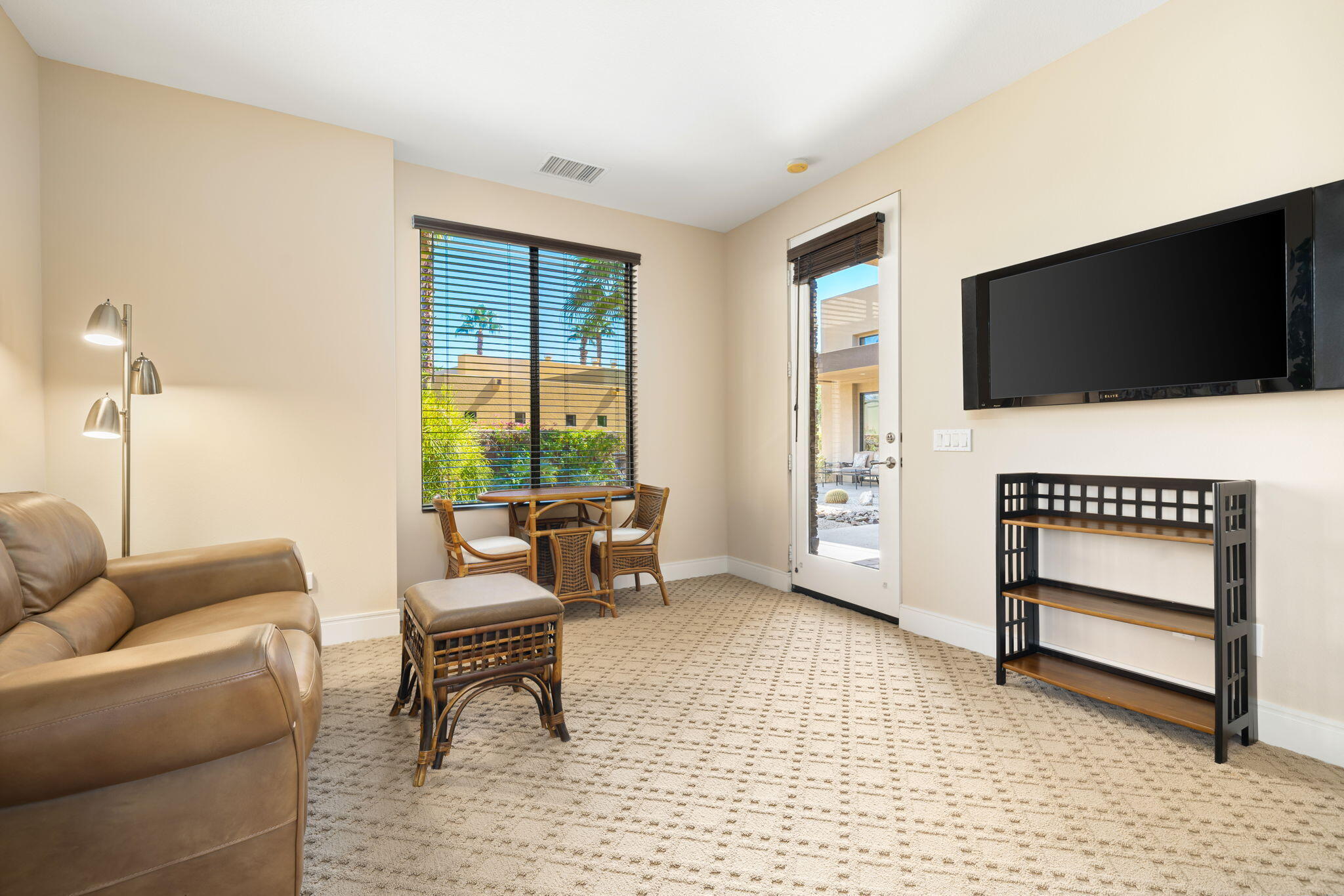 14 Dominion Court Rancho Mirage, CA 92270 - Photo 44 of 65 a living room with furniture a flat screen tv and a window