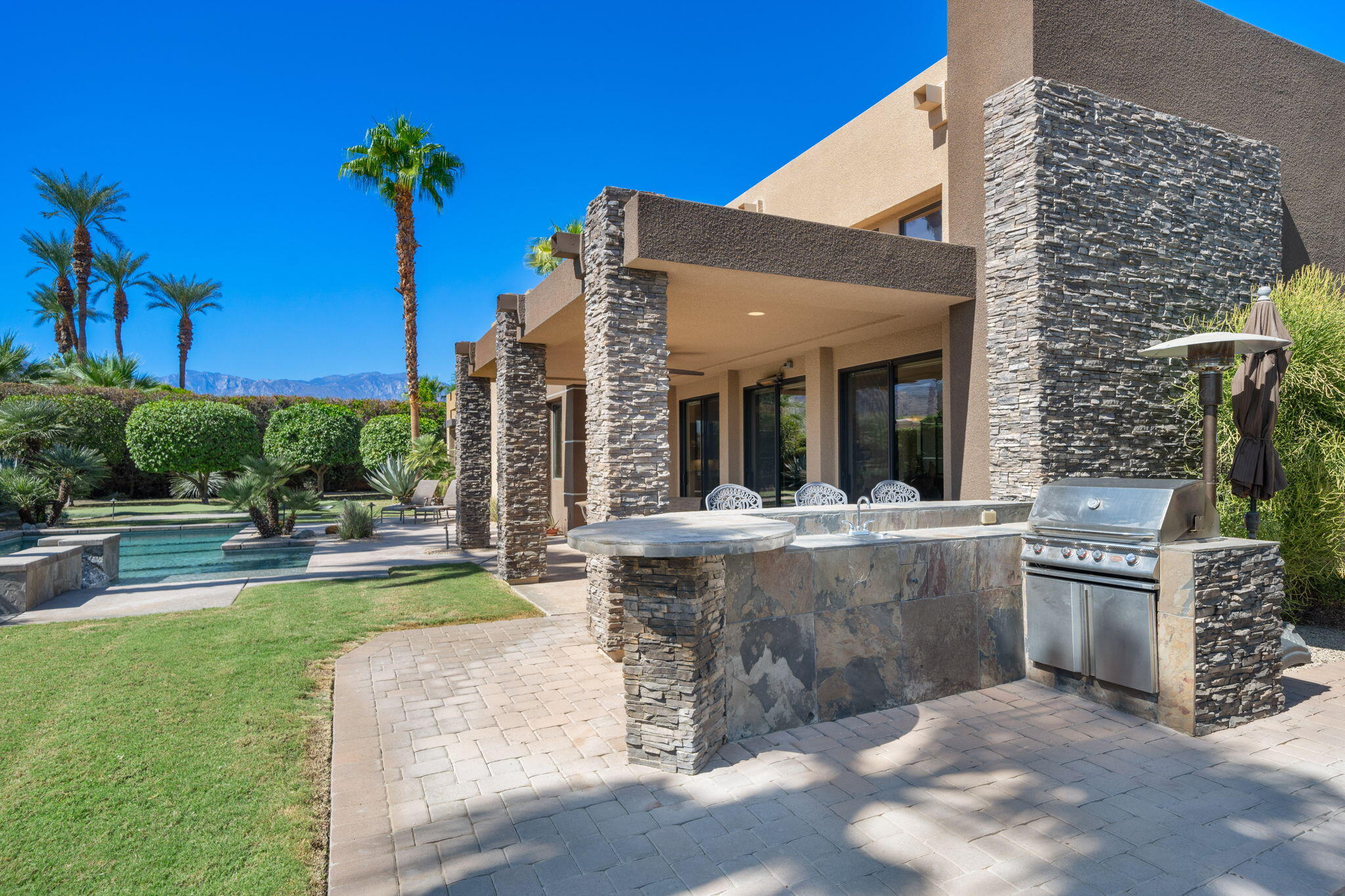 14 Dominion Court Rancho Mirage, CA 92270 - Photo 51 of 65 a view of a house with a swimming pool and sitting area