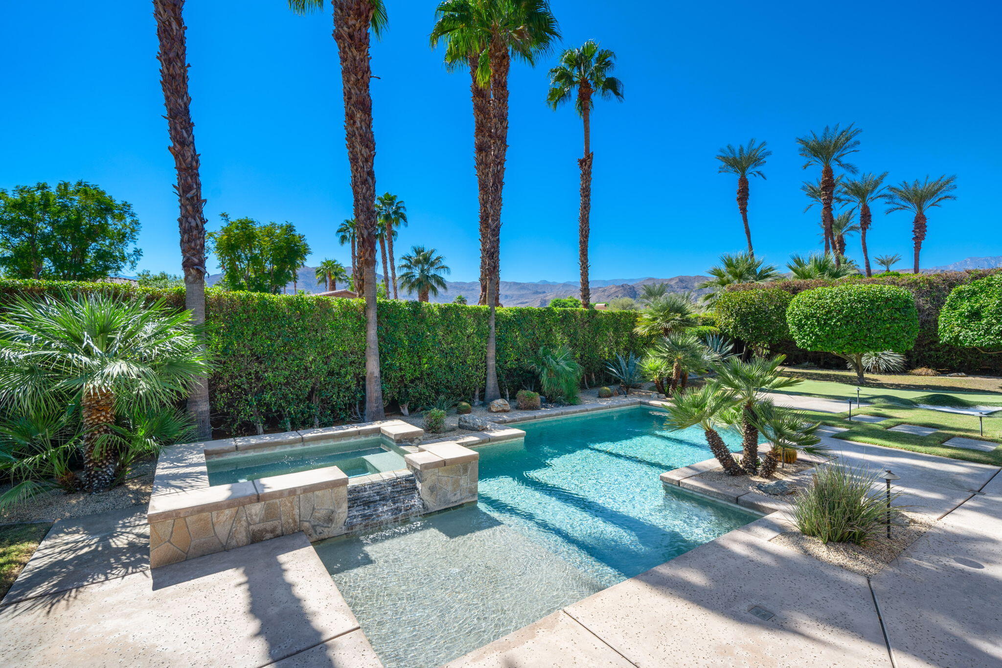 14 Dominion Court Rancho Mirage, CA 92270 - Photo 56 of 65 a view of a backyard with couches and palm trees