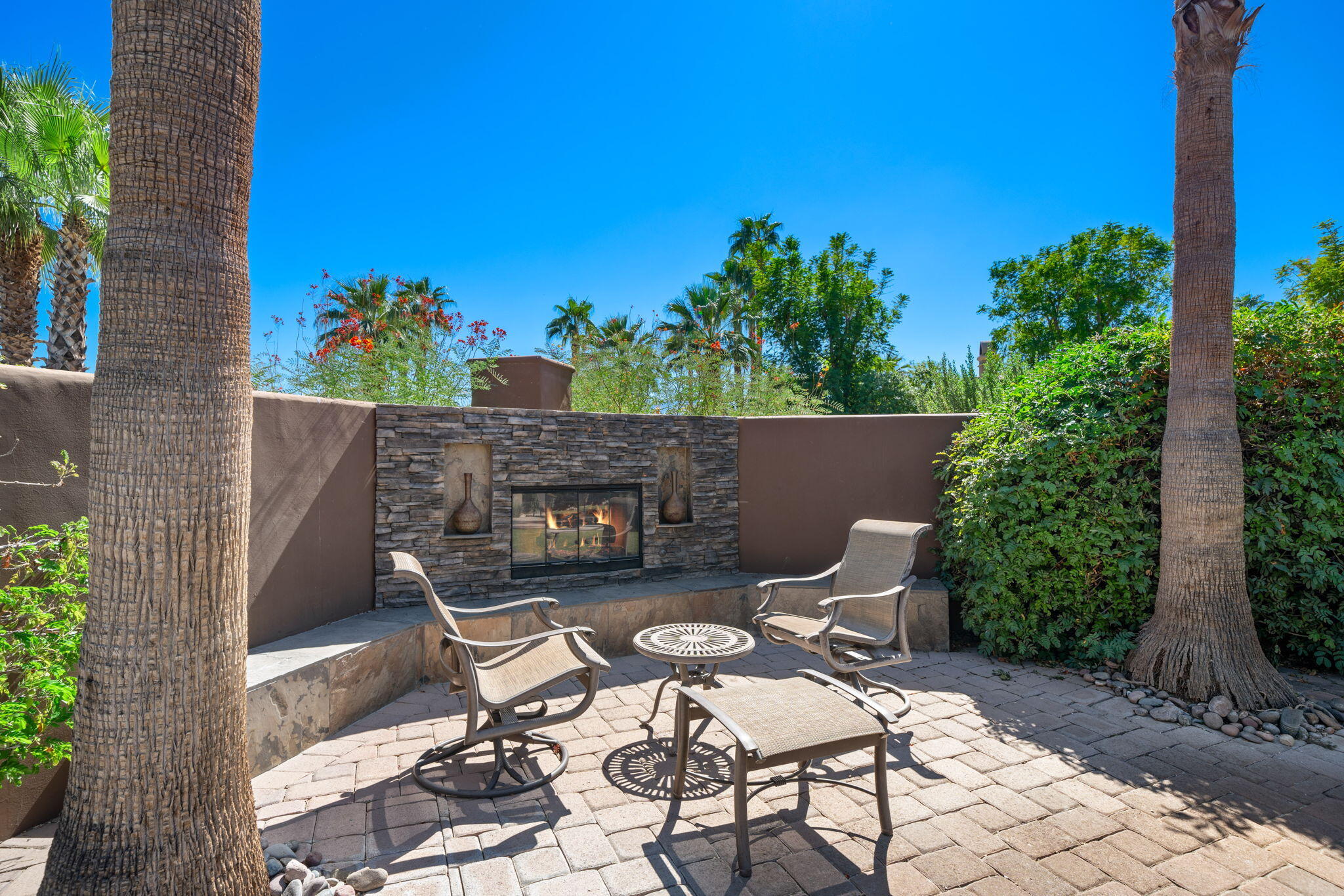 14 Dominion Court Rancho Mirage, CA 92270 - Photo 58 of 65 a view of a patio with chairs and potted plants