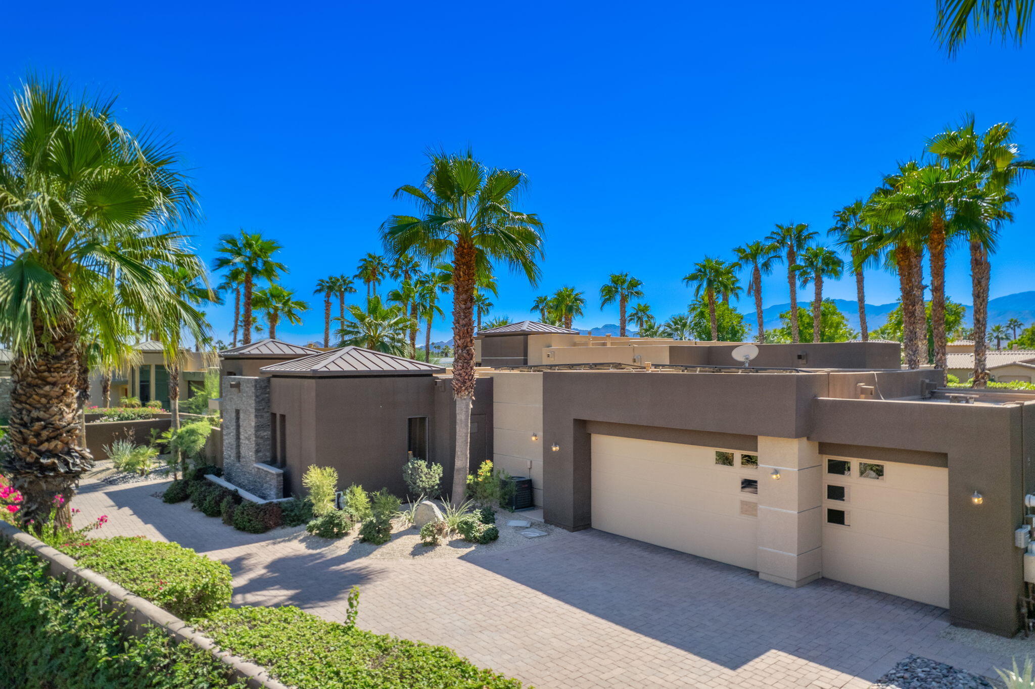14 Dominion Court Rancho Mirage, CA 92270 - Photo 6 of 65 a view of a street with a palm tree