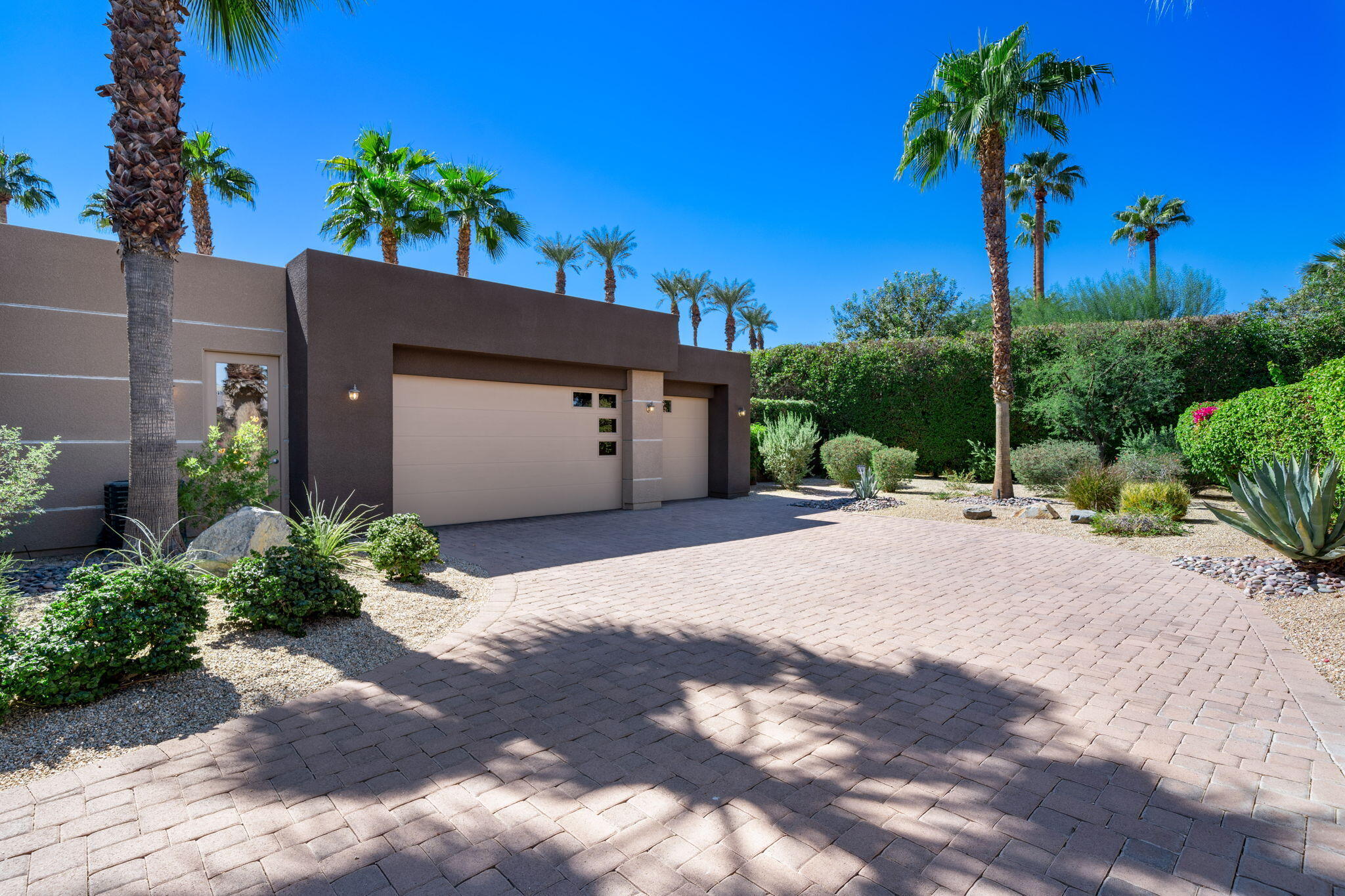 14 Dominion Court Rancho Mirage, CA 92270 - Photo 7 of 65 a view of a house with a yard and potted plants