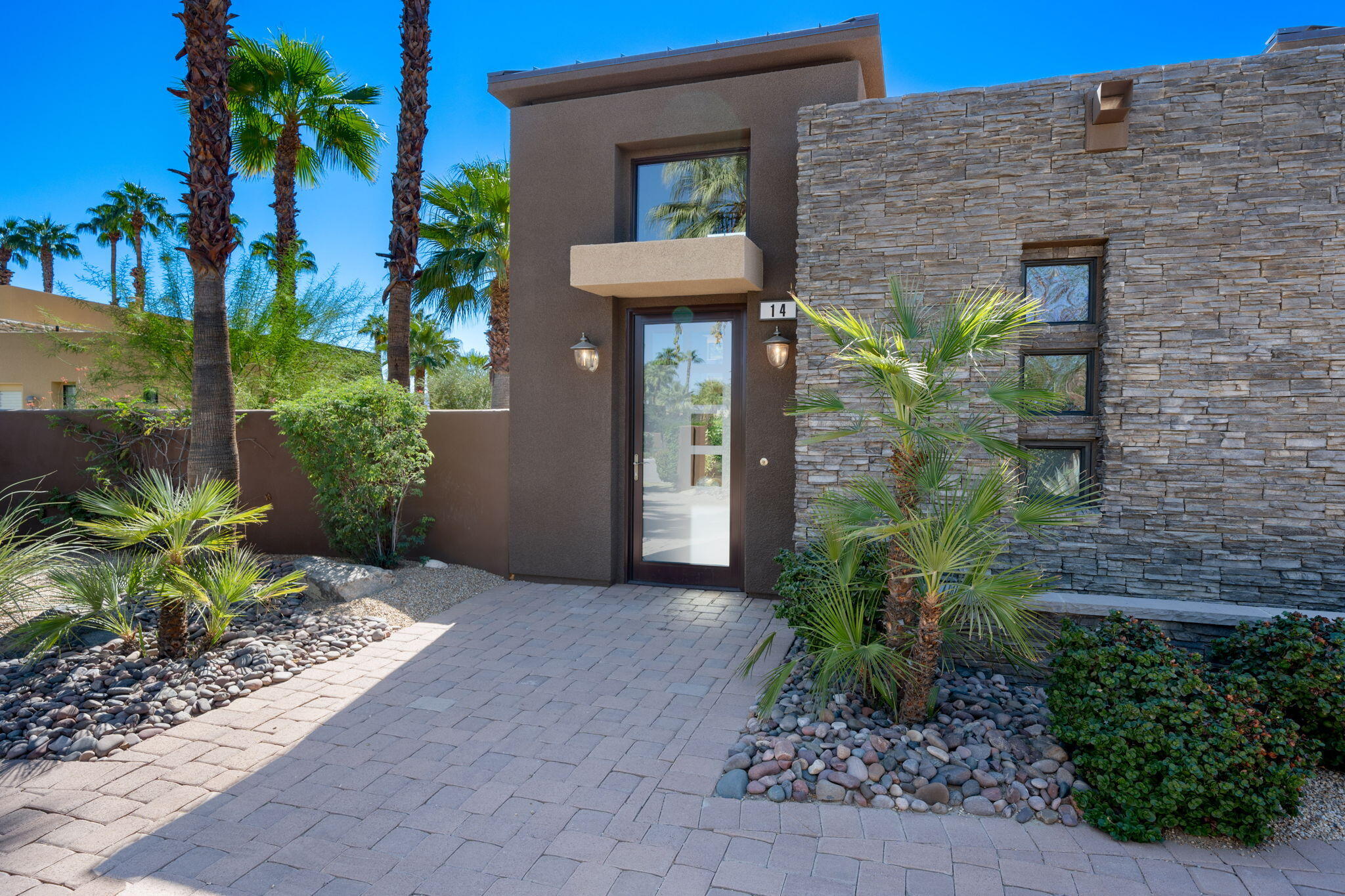 14 Dominion Court Rancho Mirage, CA 92270 - Photo 8 of 65 a front view of a house with garden