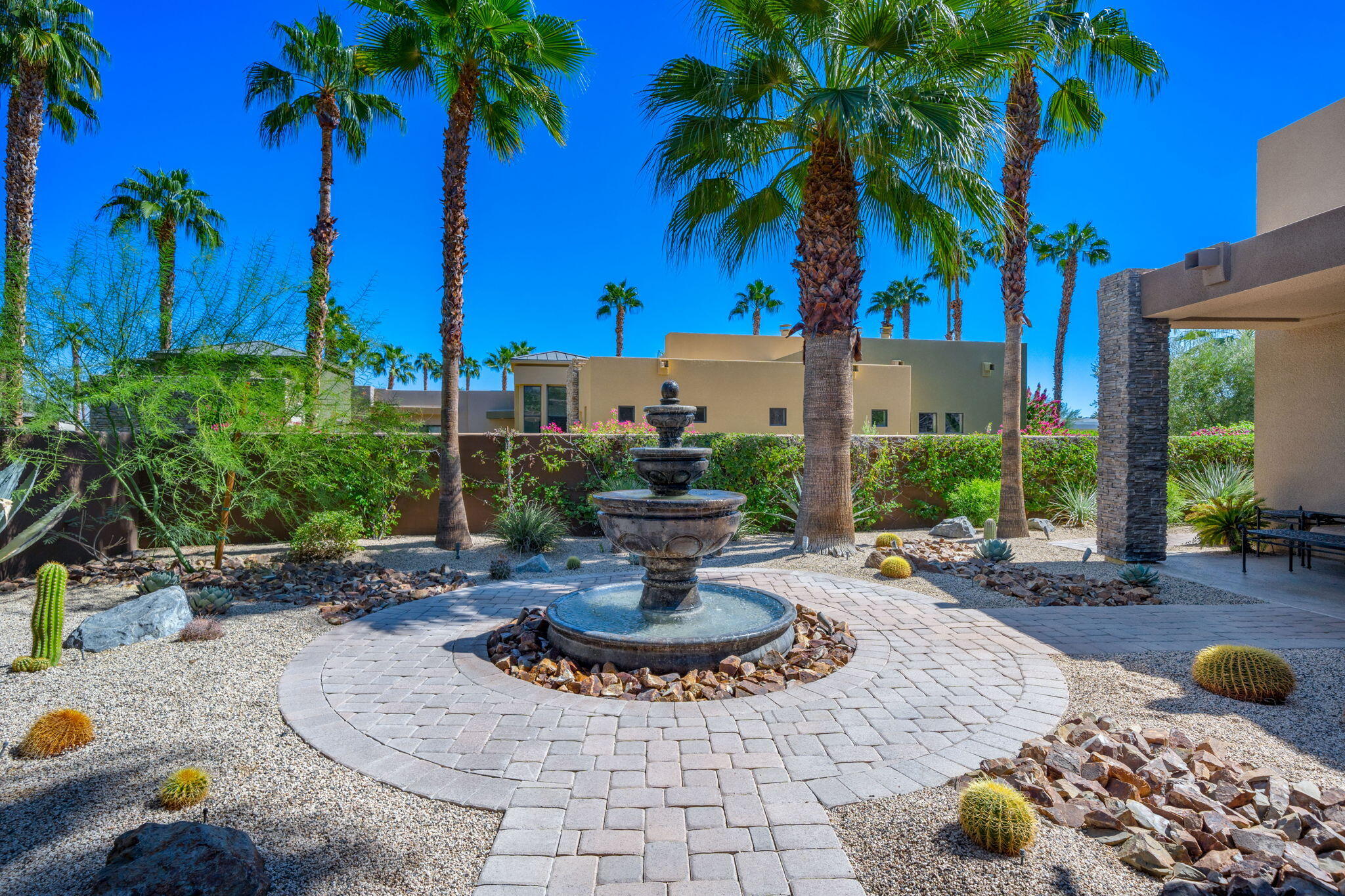 14 Dominion Court Rancho Mirage, CA 92270 - Photo 10 of 65 a view of a fountain with potted plants and palm trees