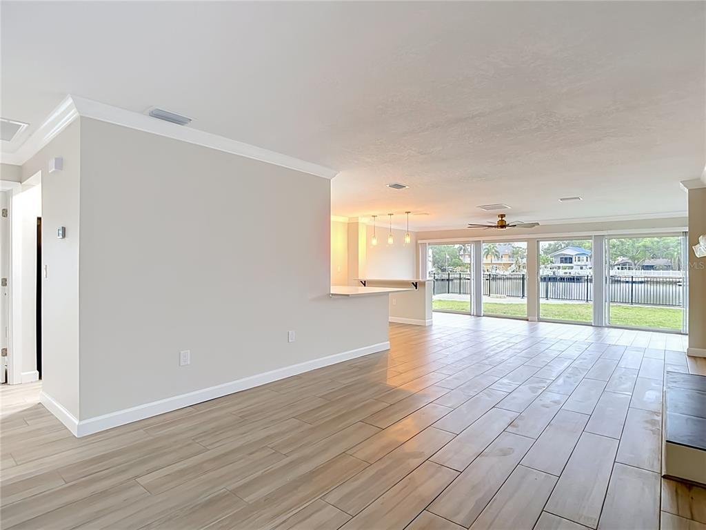 4536 Mitcher Road New Port Richey, FL 34652 - Photo 29 of 46 a view of an empty room with wooden floor and a window