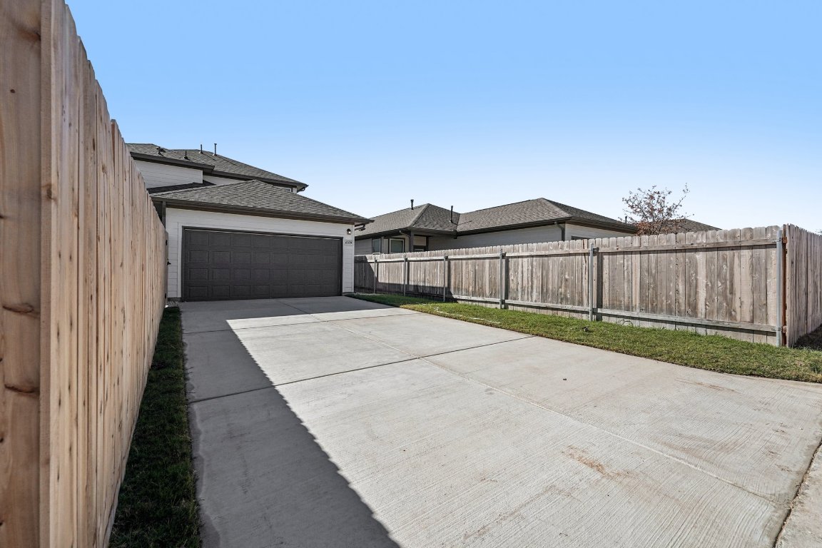 6309 Marsh Lane Buda, TX 78610 - Photo 32 of 39 a view of a house with a wooden fence