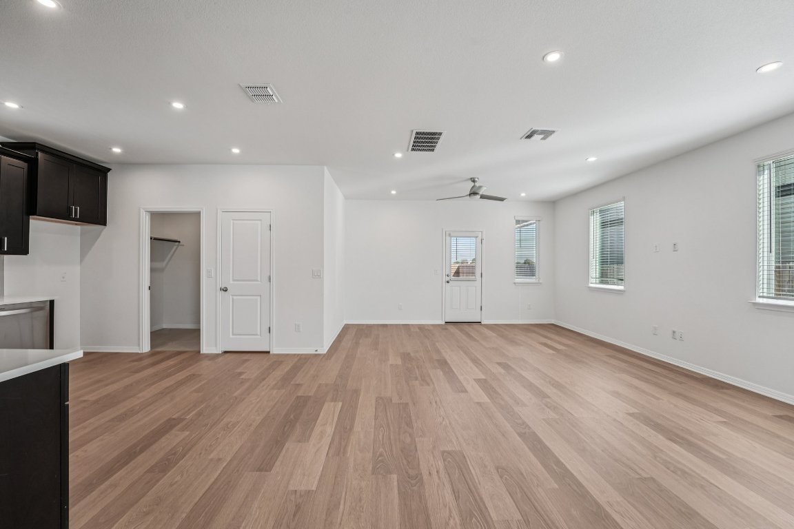 6309 Marsh Lane Buda, TX 78610 - Photo 6 of 39 a view of empty room with wooden floor and fan
