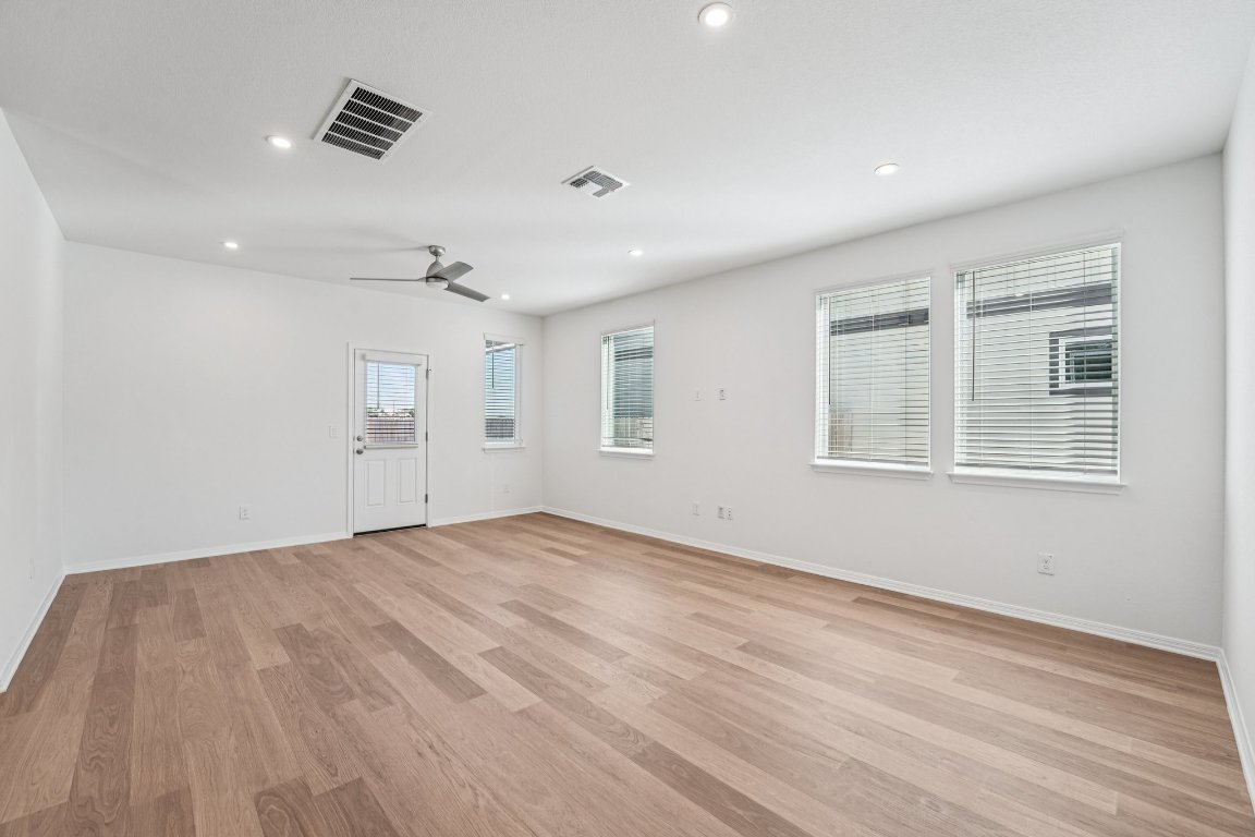 6309 Marsh Lane Buda, TX 78610 - Photo 8 of 39 a view of empty room with wooden floor and fan