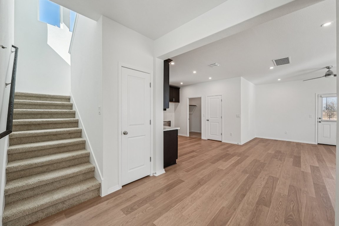 6309 Marsh Lane Buda, TX 78610 - Photo 9 of 39 a view of a hallway with wooden floor and entryway