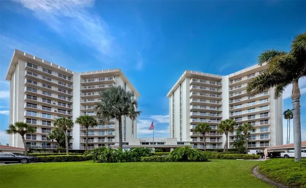 a front view of a building with a yard