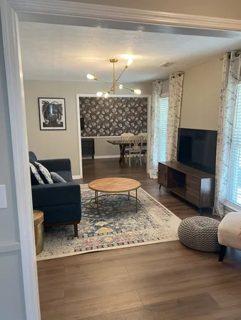 a living room with furniture and a flat screen tv