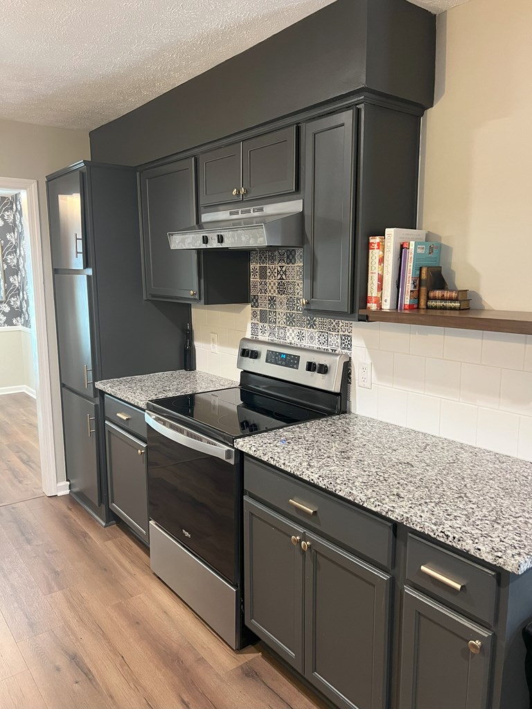 6120 Candlestick Loop Columbus, GA 31909 - Photo 5 of 20 a kitchen with stainless steel appliances granite countertop a stove and a refrigerator