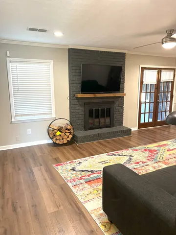 a living room with fireplace furniture and a flat screen tv