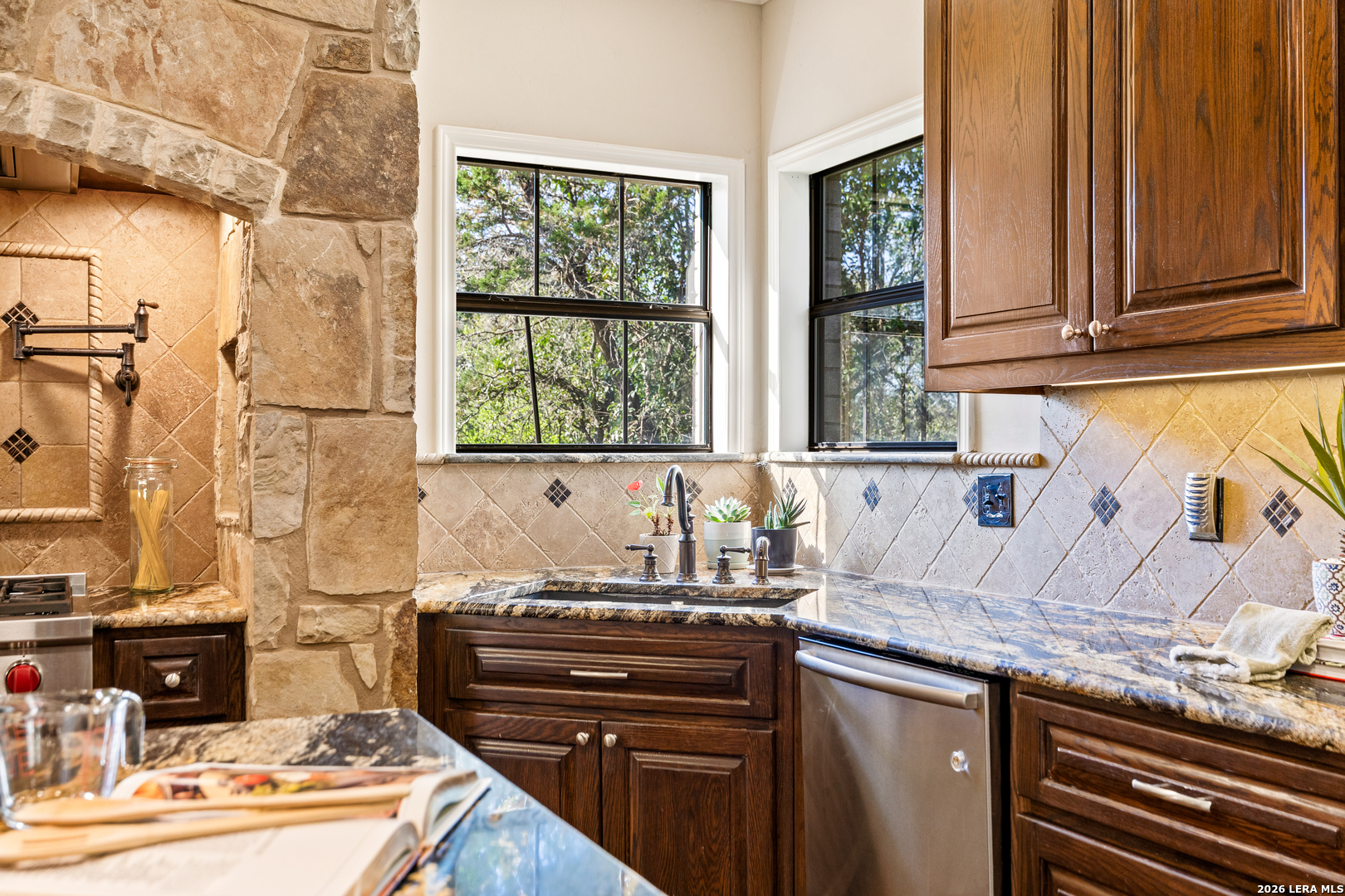 31586 Scarteen Fair Oaks Ranch, TX 78015 - Photo 25 of 67 a kitchen with granite countertop a sink and a stove