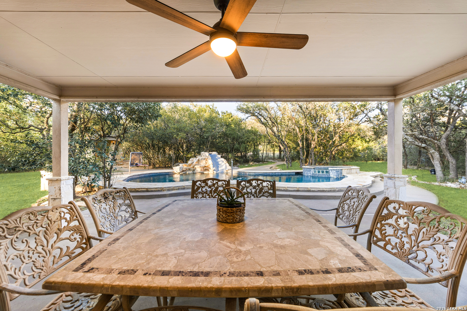 31586 Scarteen Fair Oaks Ranch, TX 78015 - Photo 40 of 67 a living room with large couches and a dining table with garden view